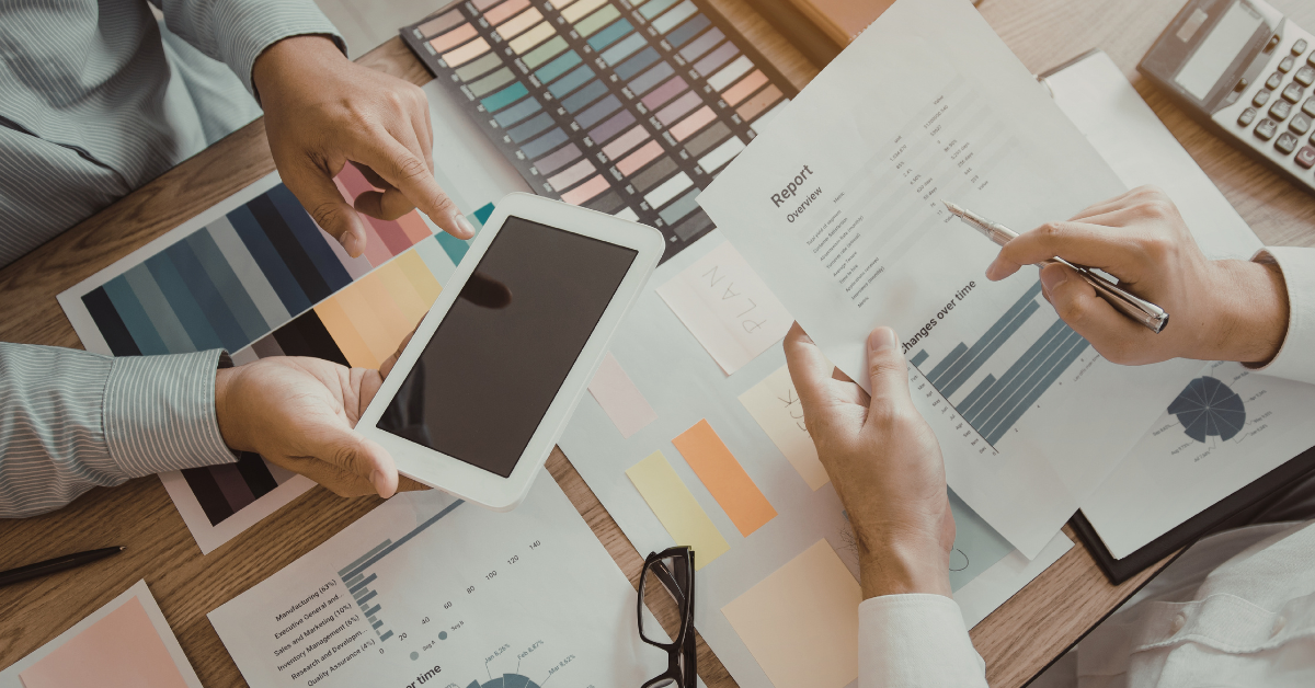 Reviewing marketing analytics reports and color charts to measure digital marketing ROI