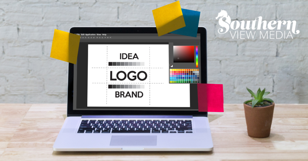 A laptop open on a wooden desk displaying a graphic design program with a layout for logo design and branding.