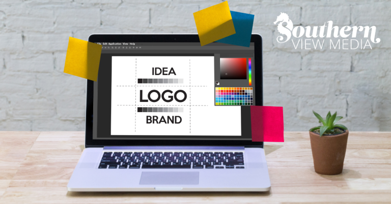 A laptop open on a wooden desk displaying a graphic design program with a layout for logo design and branding.